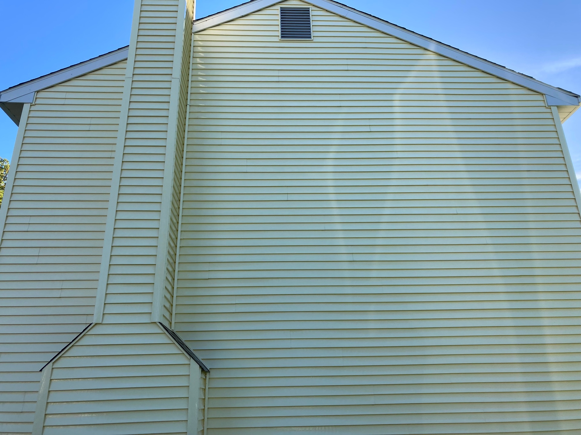 After photo showing the same siding cleaned bright and evenly