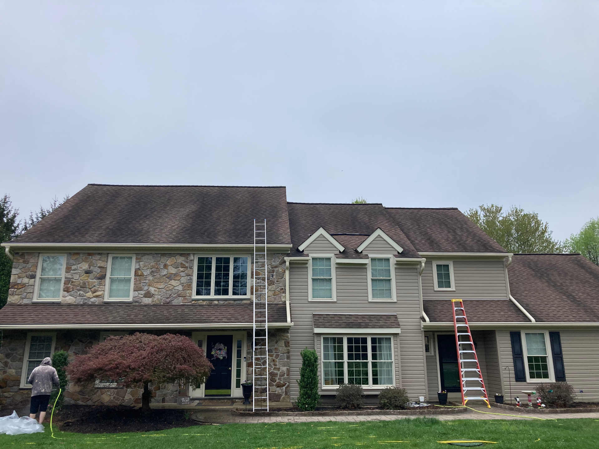 Before roof cleaning showing black streaks and algae on asphalt shingles